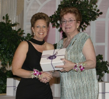 Kim Lowey (left) receiving recognition as a Finalist for the 2004 Manitoba Woman Entrepreneur of the Year Awards